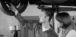 Black and White photo of an Auto Mechanic talking to a customer at Auto Repair Center